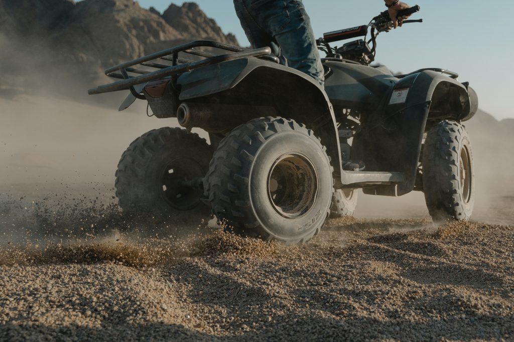 ATV taking off in a sand track