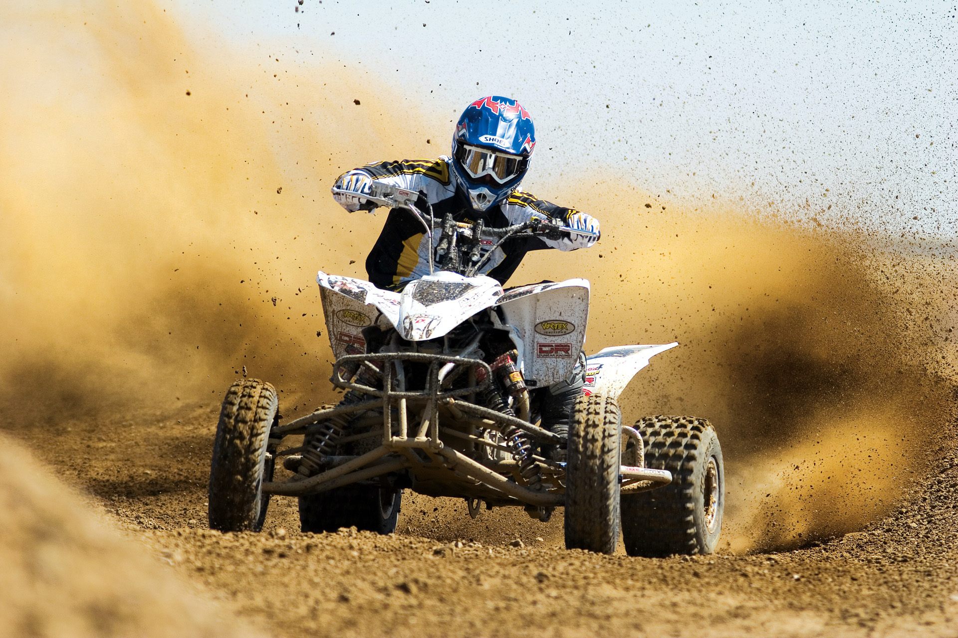 Man riding ATV on a mud track