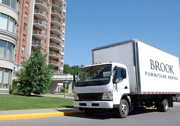 Brook Delivery truck park in front of luxurious condominium building.