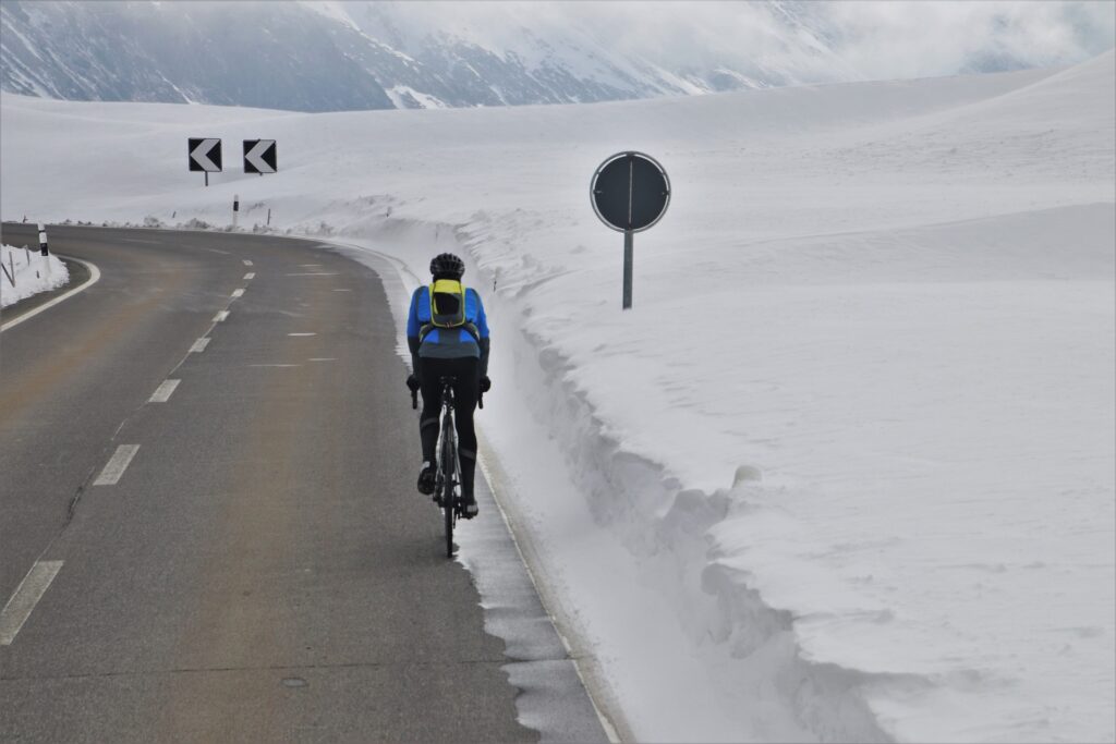 Man cycles in snow