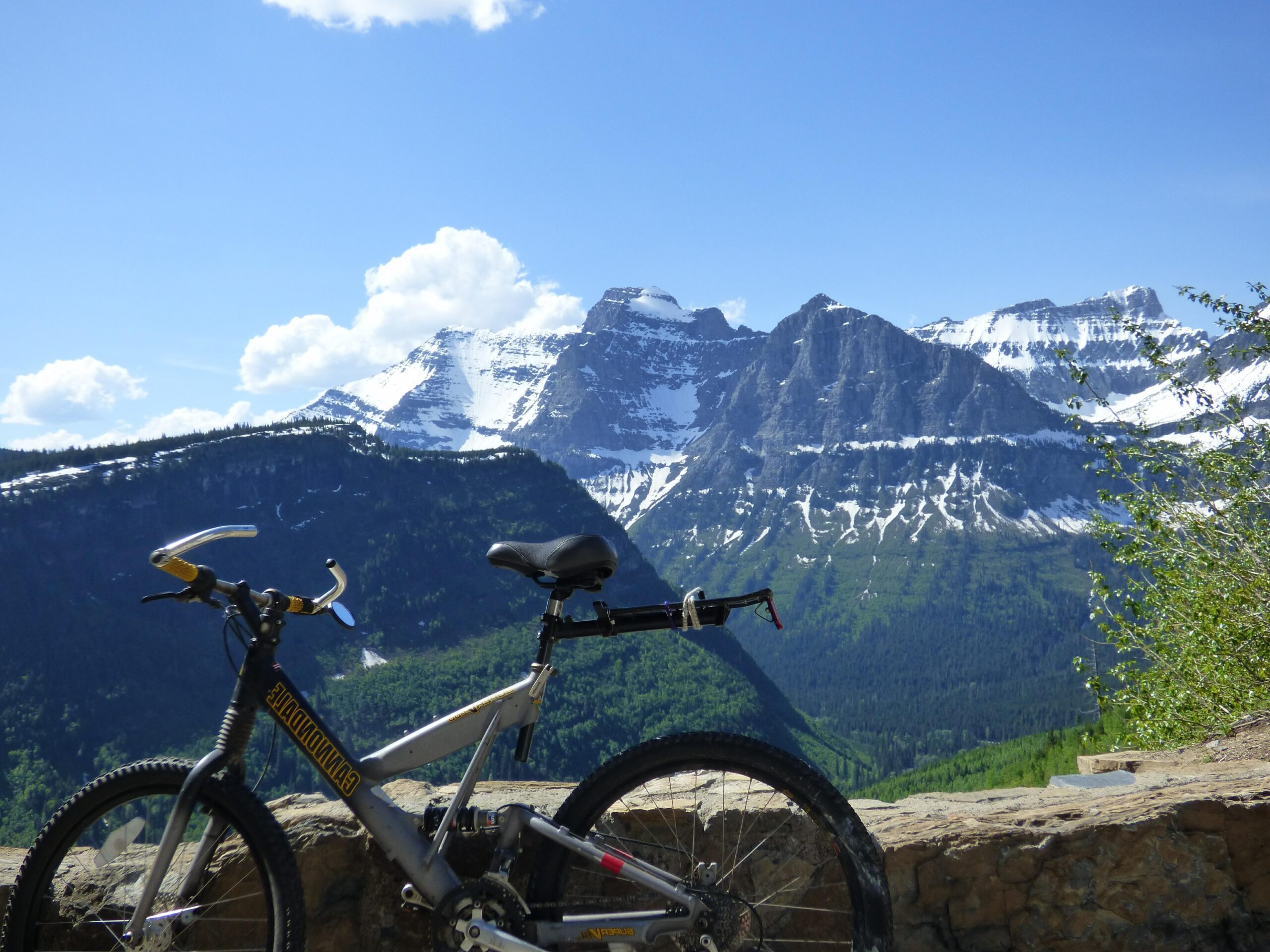 Bike parked beside Going-to-the-sun road with mountain in background